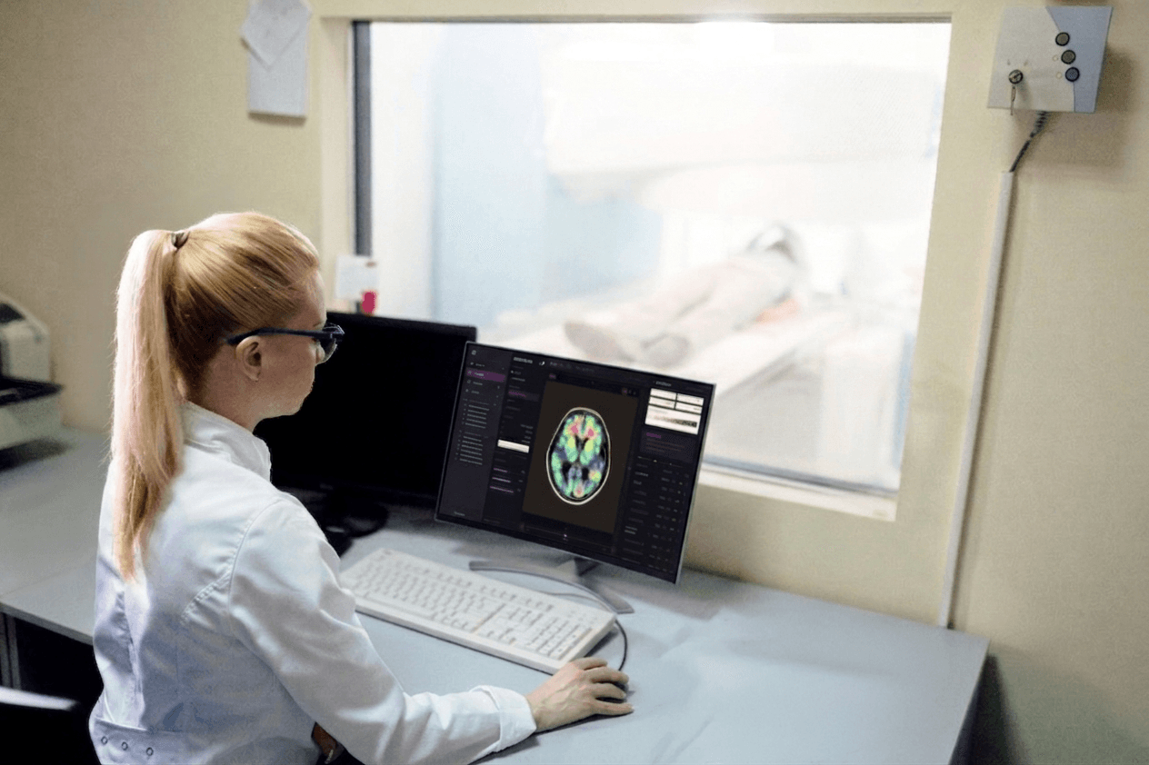 Researcher reviewing a brain scan next to an MRI room
